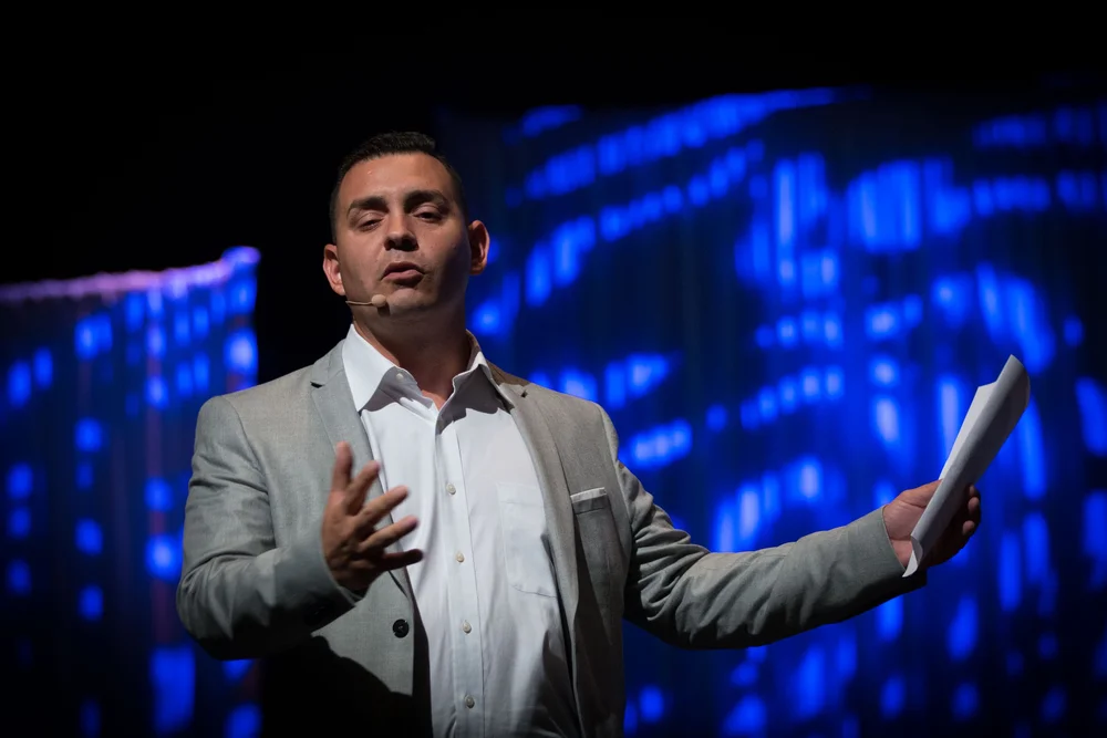 Javier speaking on stage