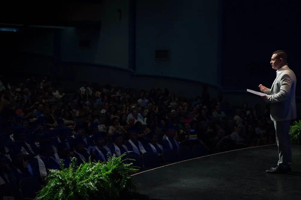 Javier on stage addressing an audience
